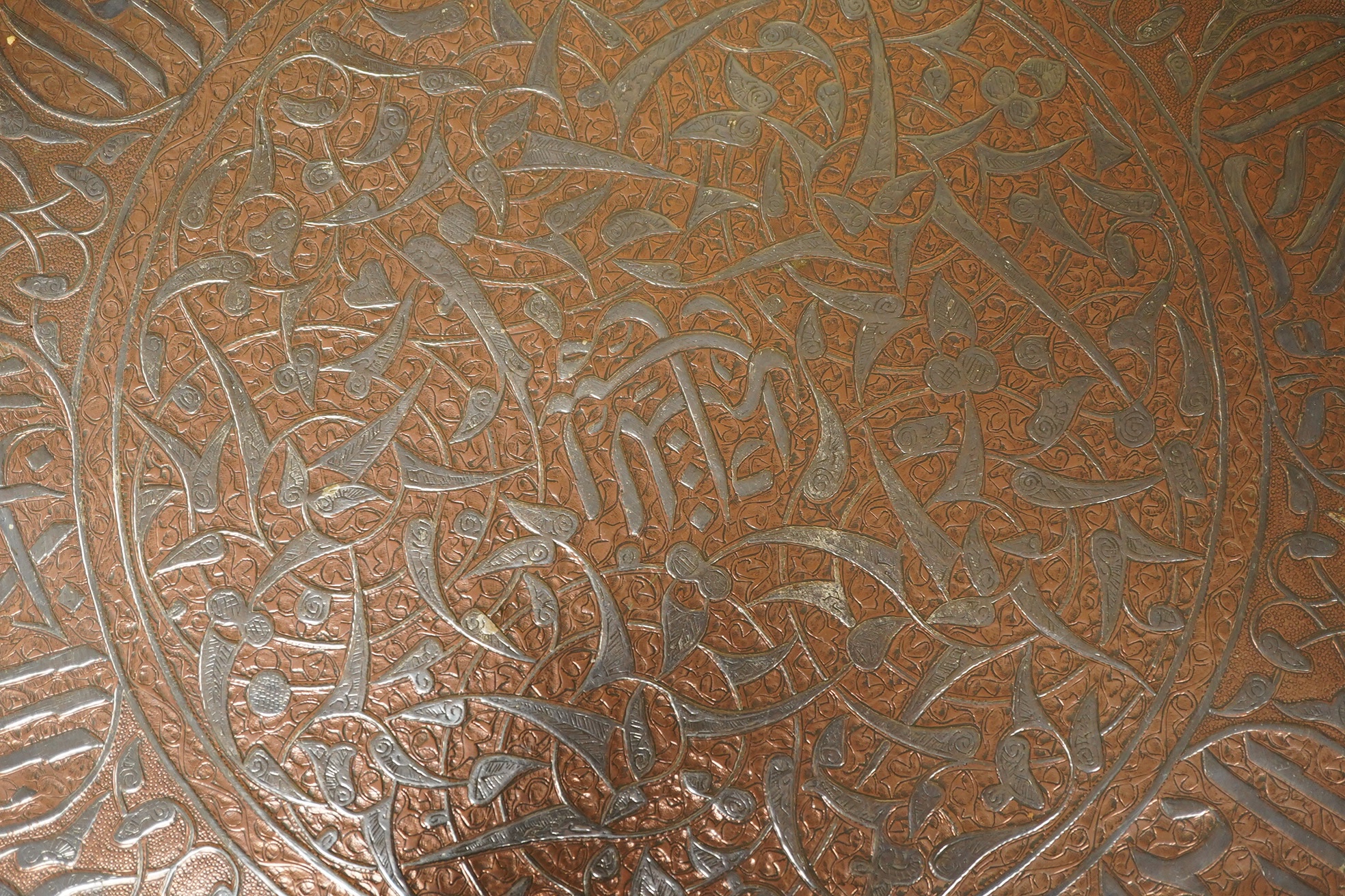 A Middle Eastern circular copper and niello damascened tray, 50cm in diameter. Condition - good